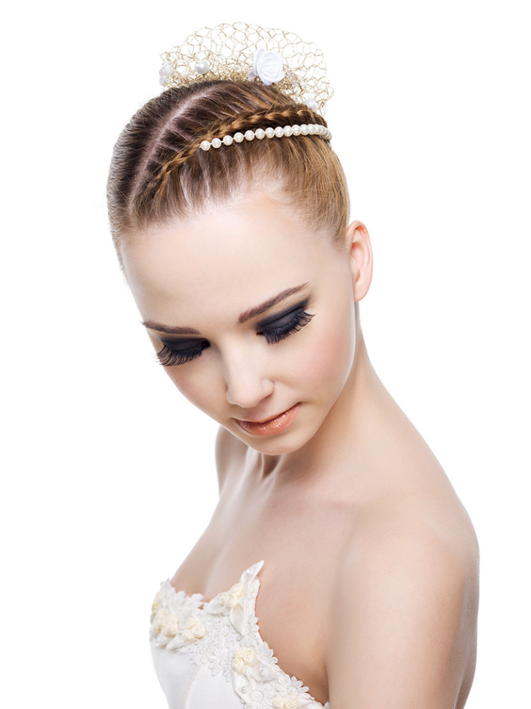 Beautiful woman with wedding hairstyle of pigtail. On white background